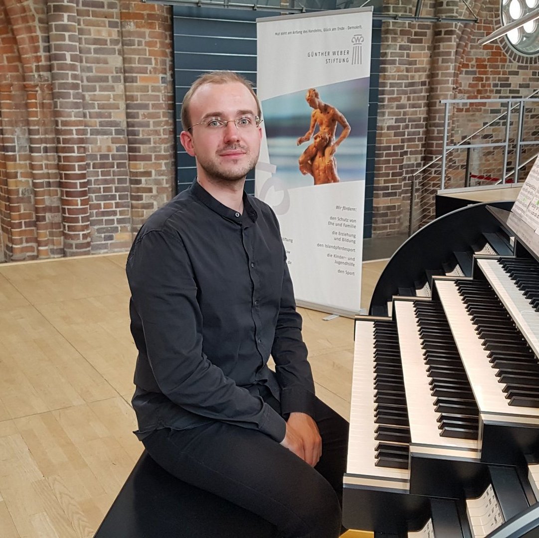 Eine Person sitzt an einer Orgel